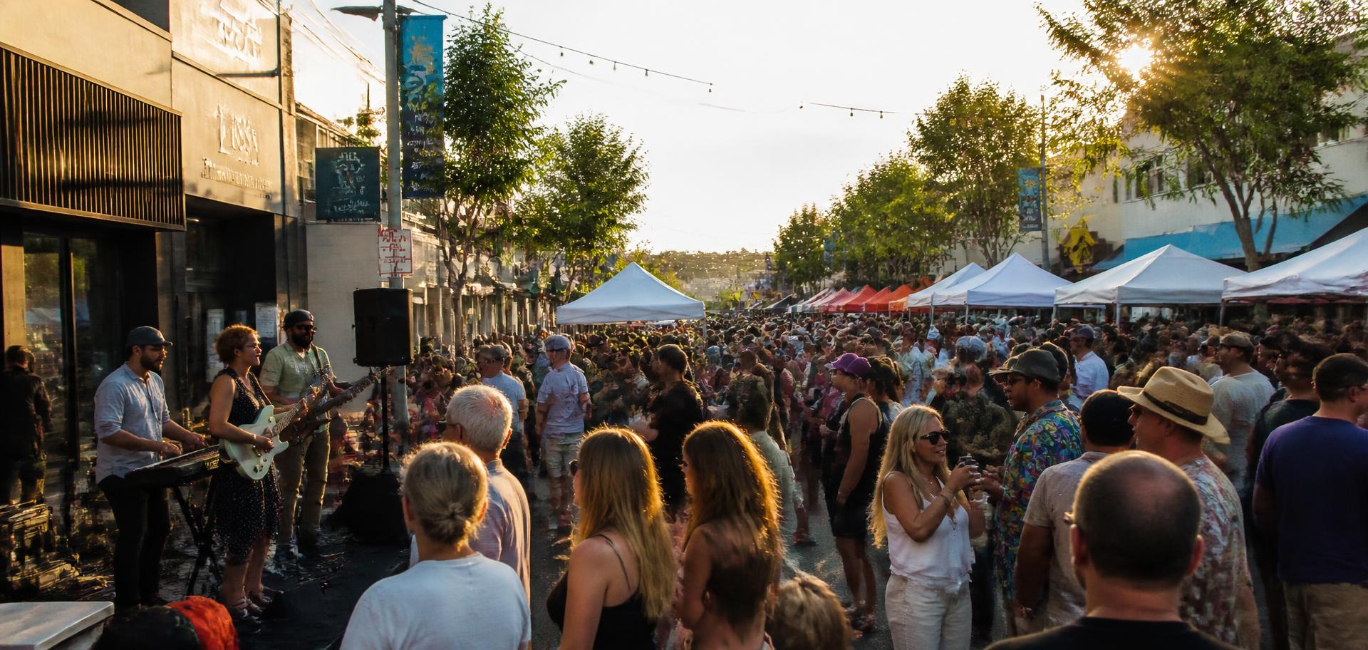 Lively community street festival in a commercial corridor